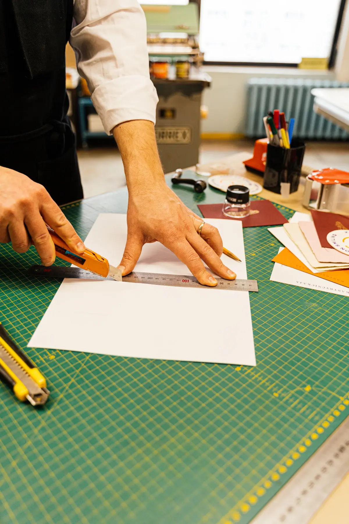 Hands measuring and reviewing a precise customer workflow